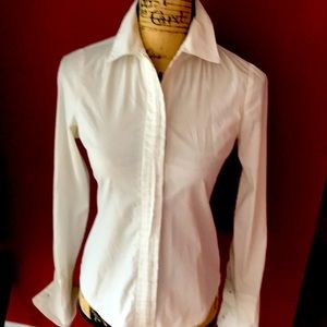 Classic white button down blouse with cuffs .